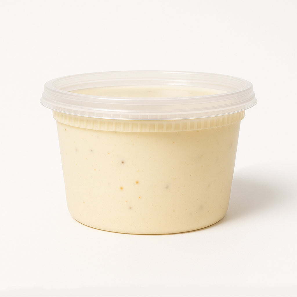 Beige container with Mac and cheese in a clear lid on a white background