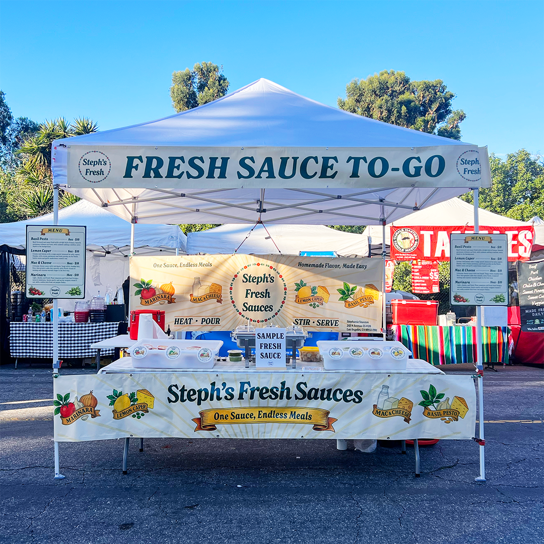 Steph's Fresh Sauces booth at an outdoor event with a clear blue sky.