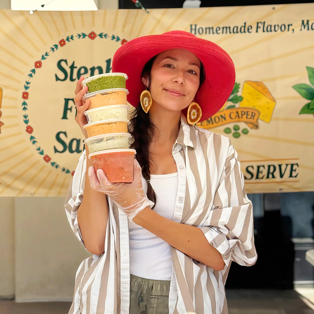 steph holding 6 containers of sauce 